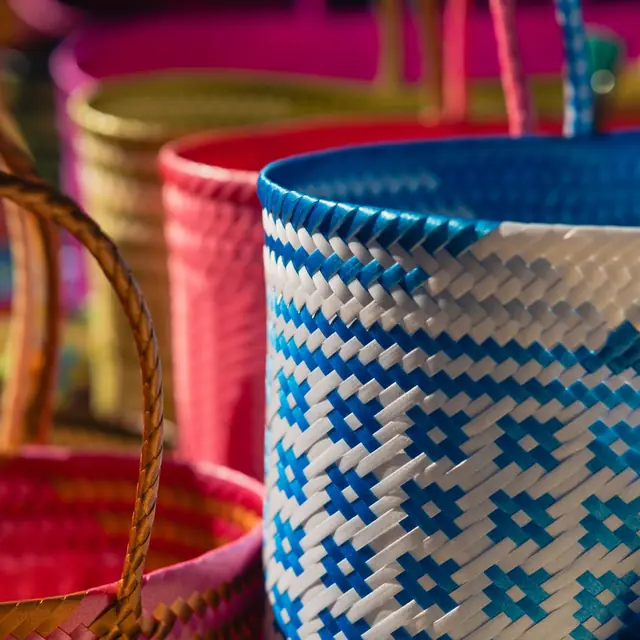 Bright blue and white woven basket with a cane handle