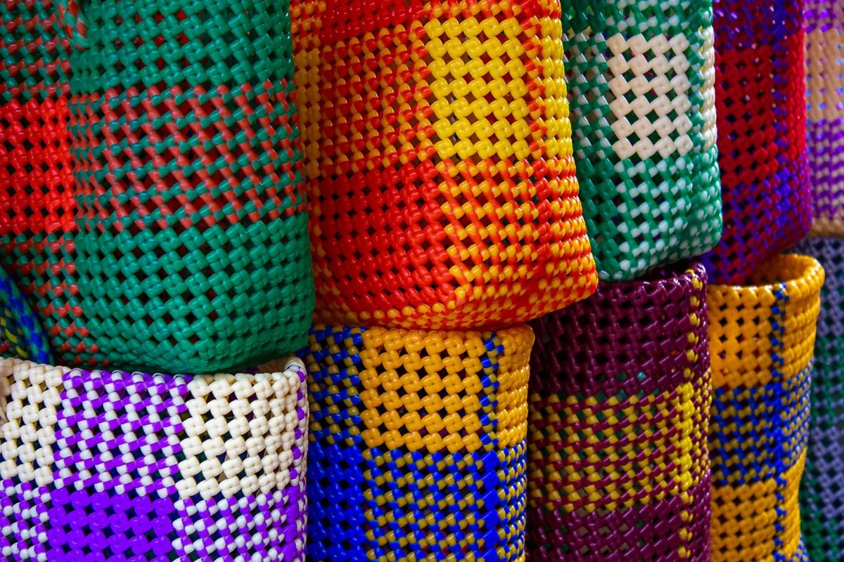 Stacks of bright hand-woven baskets in green, red, yellow and purple