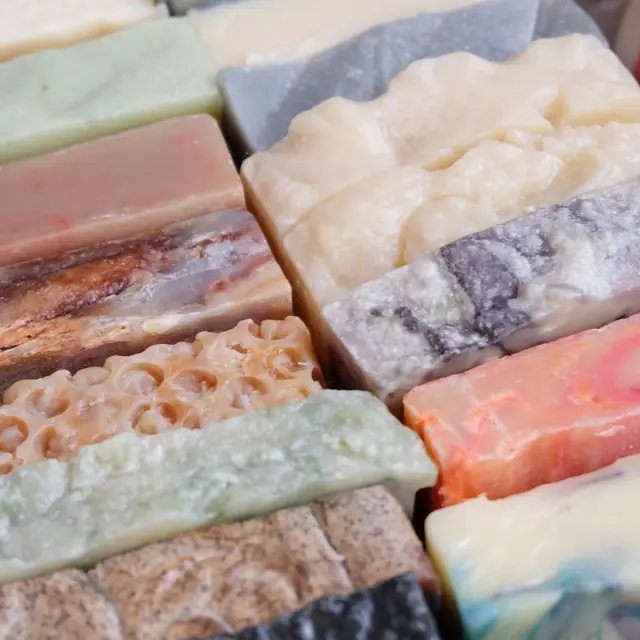 Colourful hand-cut soap slabs in swirled terracotta, mauve and cream